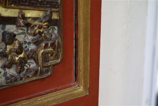 A Chinese gilt and red lacquered relief panel 84 x 32cm
